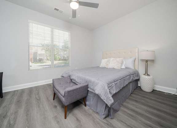 a bedroom with a bed and a ceiling fan