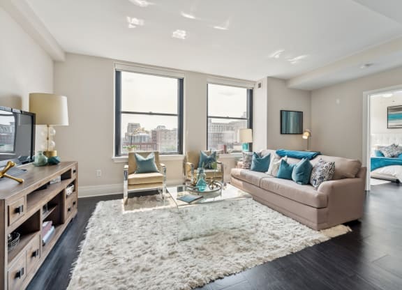 a living room with a couch chairs and a tv