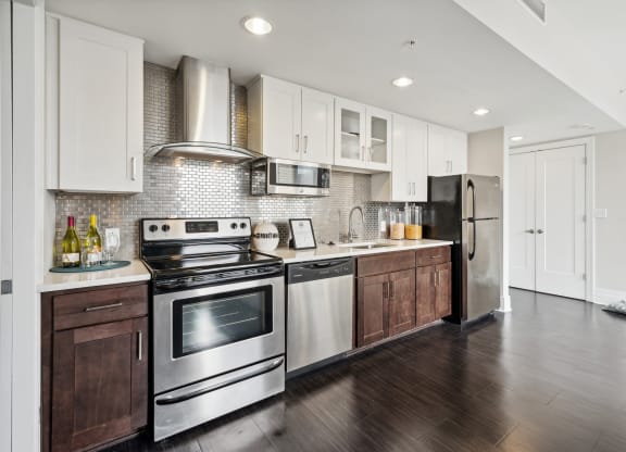 a kitchen with white cabinets and stainless steel appliances