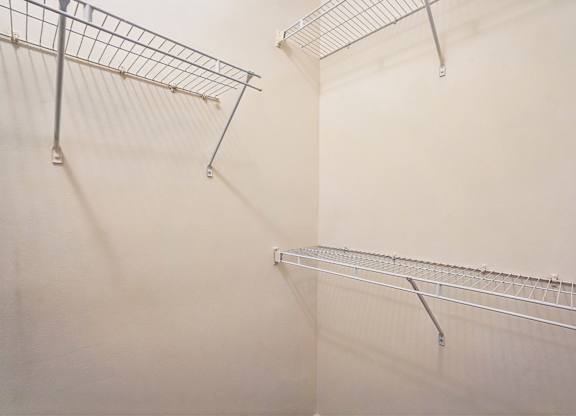 A white wall with a metal rack on it.