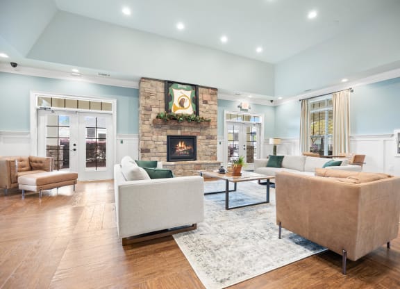 a living room with couches and chairs and a fireplace