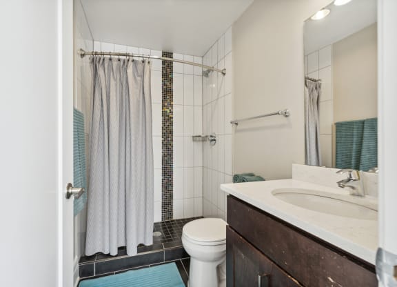 a bathroom with a toilet sink and shower