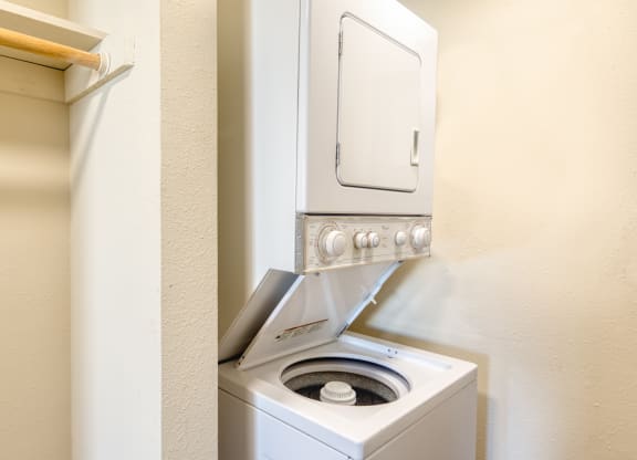a washer and dryer in a bathroom with a washing machine