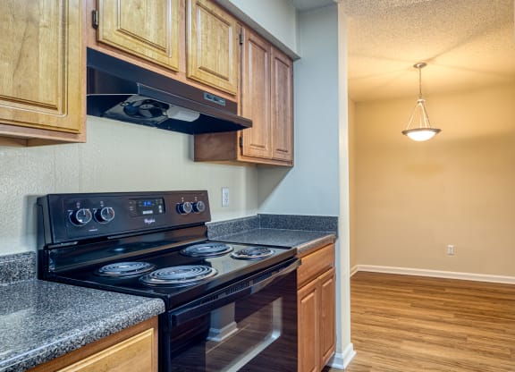 the kitchen of a home with wood cabinets and black appliances