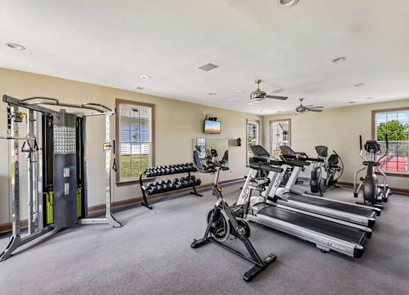A spacious home gym with a variety of exercise equipment.
