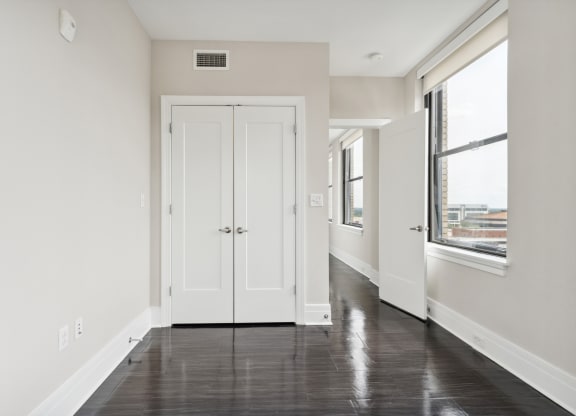 a bedroom with white walls and a black and white floor