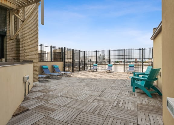 a patio with chairs and a grill at the villas at falling waters in west omaha
