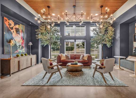 A modern living room with a large window, a sofa set, and a coffee table.