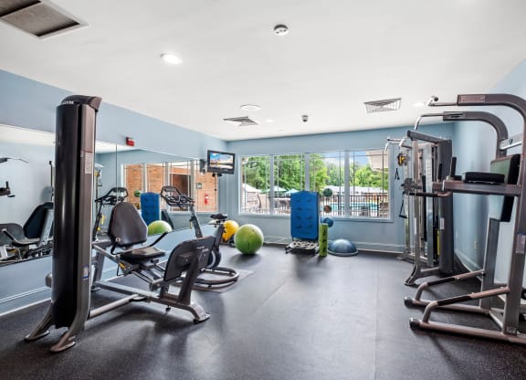 a gym with exercise equipment and a large window