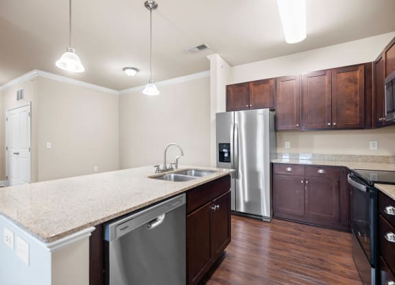 a kitchen with stainless steel appliances and a marble counter top