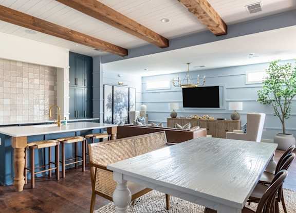 A modern kitchen with a dining table and chairs.