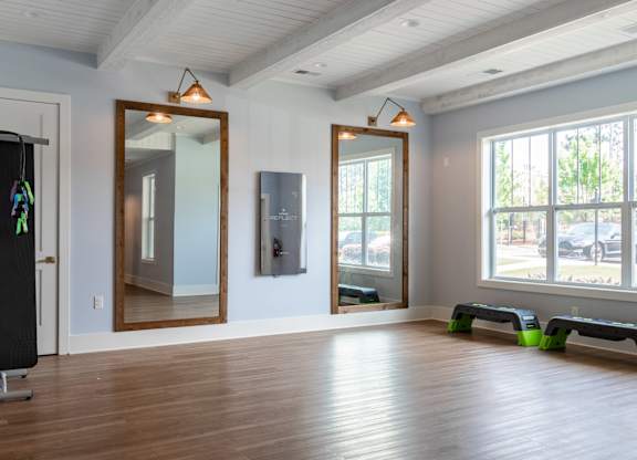 A room with a blackboard on the left and a mirror on the wall.