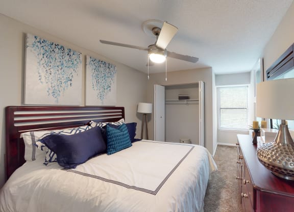 a bedroom with a large bed and a ceiling fan