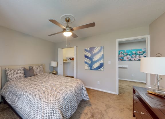 a bedroom with a bed and a ceiling fan