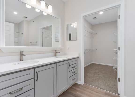 a bathroom with a sink and a mirror and a shower  at The Charleston, Ohio