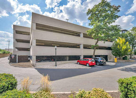 A parking garage with a red car parked in the lower level.