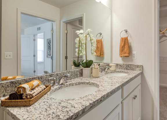 A bathroom with a marble countertop and double sinks at The Mark Townhomes Apartments, Harrisonburg, VA, 22801