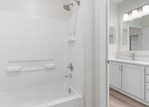 a white bathroom with a tub and a sink  at The Charleston, Columbus, Ohio