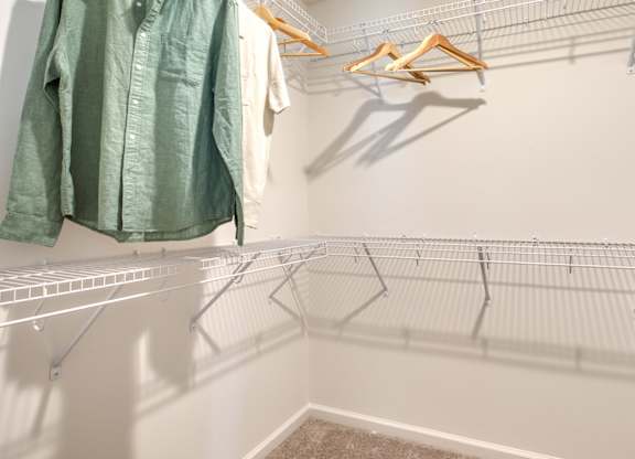 Clothes hanging on a rack in a room at The Mark Townhomes Apartments, Harrisonburg, VA