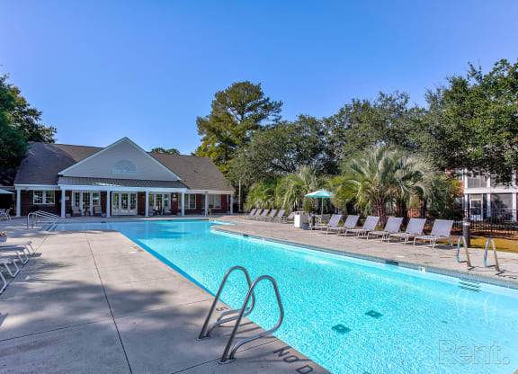 a swimming pool with chairs and a building in the backgroundat Barclay Place Apartments, Wilmington