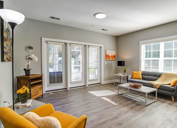 a living room with a couch and a table at Barclay Place Apartments, Wilmington