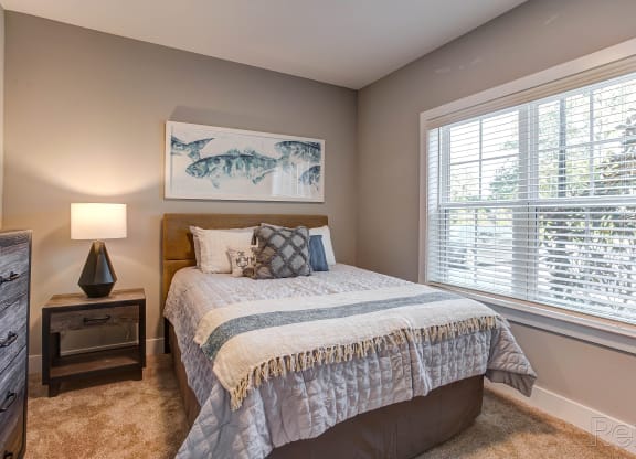 a bedroom with a bed and a large window at Barclay Place Apartments, North Carolina