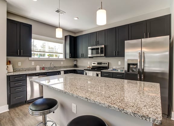 a kitchen with granite counter tops and stainless steel appliances at Barclay Place Apartments, Wilmington, 28412