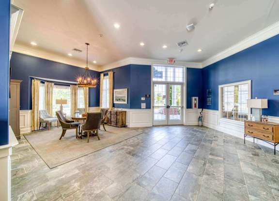 A spacious room with a dining table and chairs.