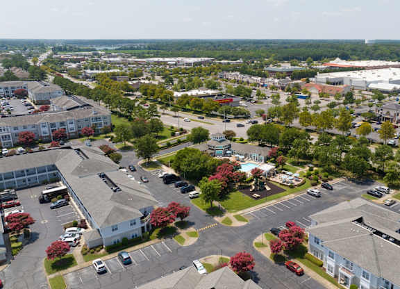 A bird's eye view of a parking lot surrounded by buildings.