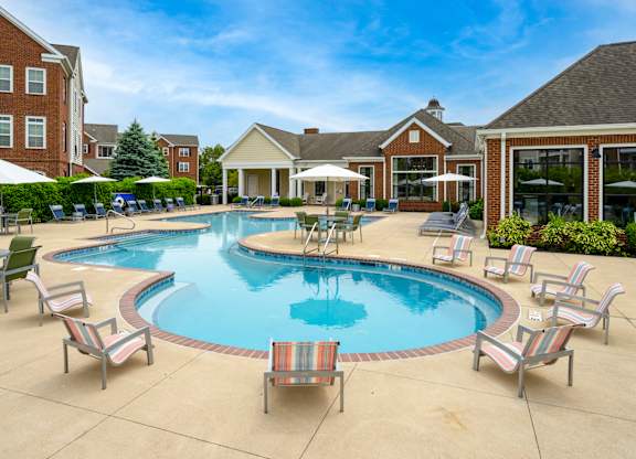 A large outdoor swimming pool surrounded by lounge chairs.at Arlington Park, Hilliard Ohio