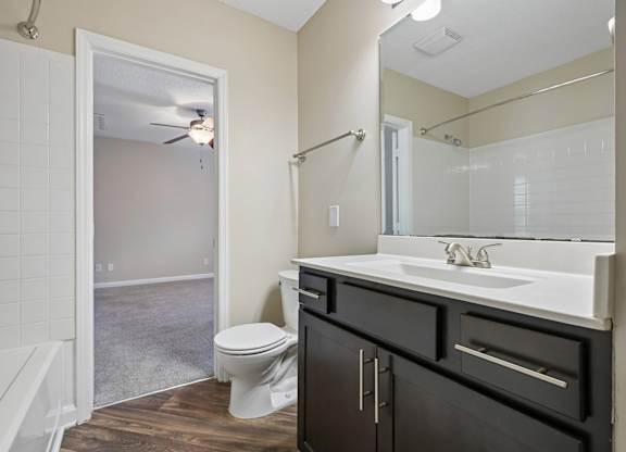 A bathroom with a toilet, sink, and shower.