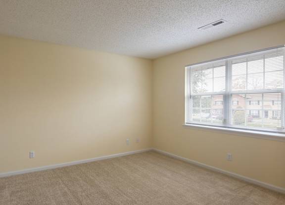 A room with a window and a door.