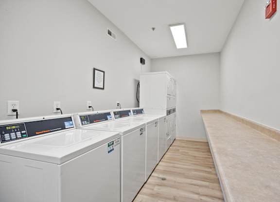 A laundry room with washers and dryers.