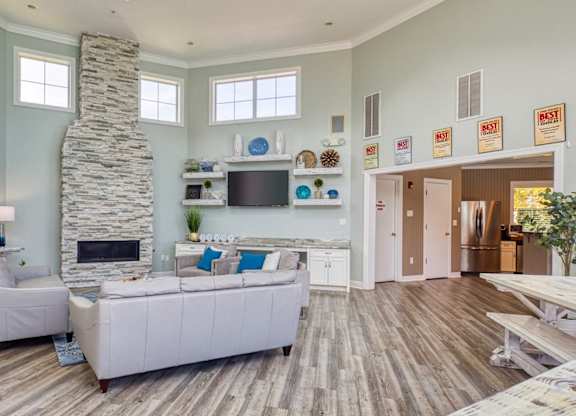 A living room with a stone fireplace and a white couch.