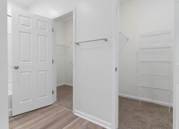 an empty bedroom with a closet and a white door at The Charleston, Columbus, OH