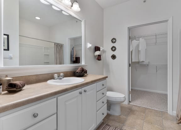 a bathroom with a sink and a toilet and a shower at The Charleston, Columbus