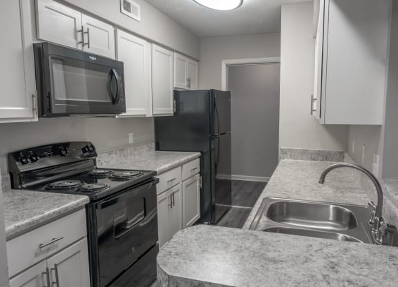 an empty kitchen with granite counter tops and stainless steel appliances