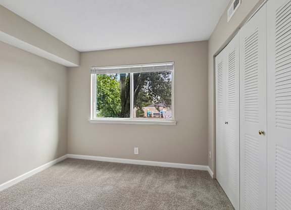 A room with a window and a door.