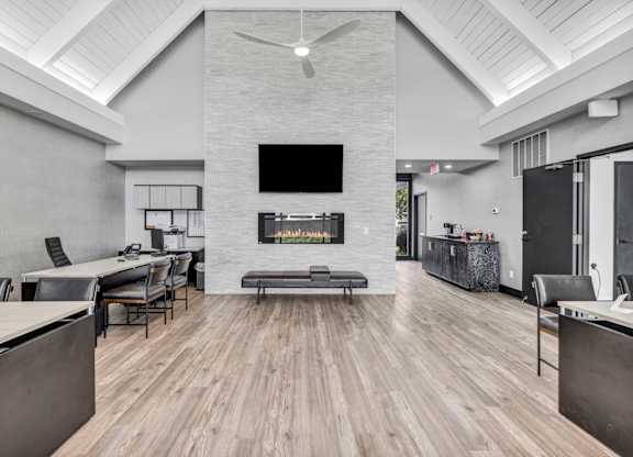 A modern living room with a fireplace and a television.