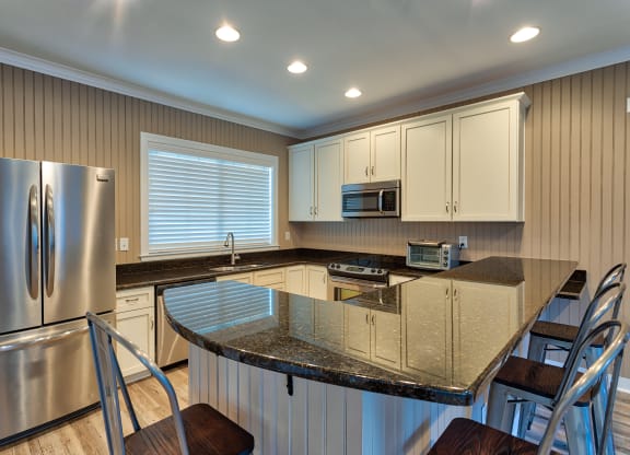 a kitchen with an island with a granite countertop