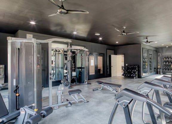 a room filled with lots of different types of gym equipment