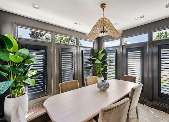 A dining room with a round table and chairs.