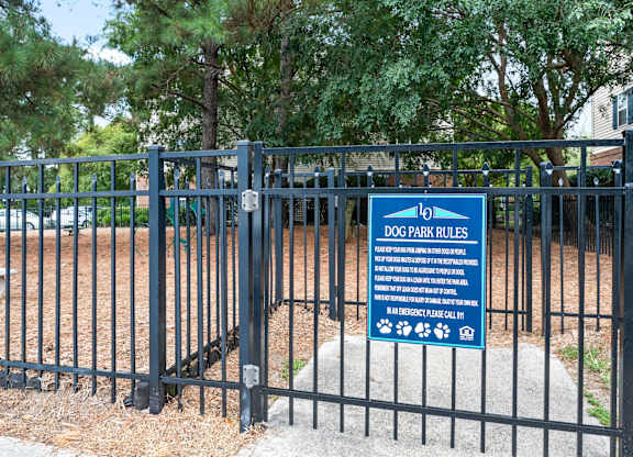 A sign for Dog Park Rules is posted on a fence at Litchfield Oaks Apartments in Pawleys Island, SC, 29585
