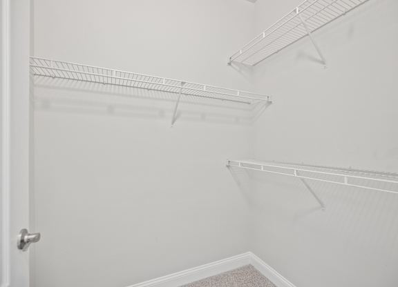Empty white shelves in a room.