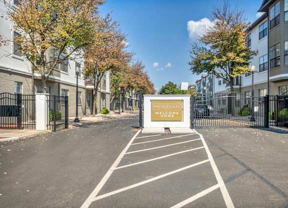A Meridiani sign is displayed on a building in a parking lot.