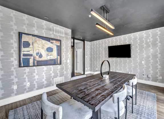 A dining room with a wooden table and chairs.