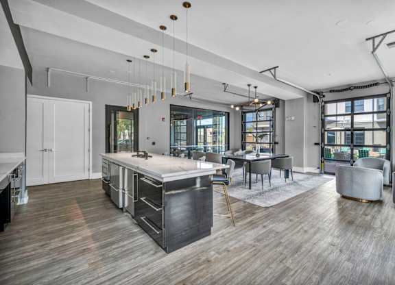 A modern kitchen with a wooden floor and a large island.