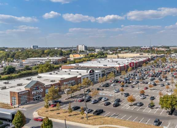 A large parking lot in front of a shopping center.