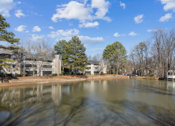 a view of a lake with apartments in the background