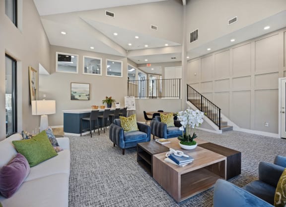 a living room with furniture and a staircase